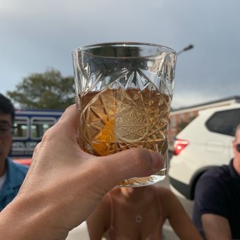 Holt's - a person holding a glass of beer - Pizza Near Me - Park Ridge, Illinois