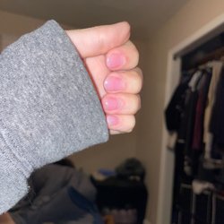 Polished - Tips placed on the top two fingers and pinky.