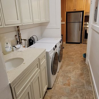 A2Z Remodeling - Laundry area with new vanity cabinet with sink, new overhead cabinets, new flooring and new washer and dryer and paint - General Contractors Near Me - San Francisco, California A2Z Remodeling - Laundry area with new vanity cabinet with sink, new overhead cabinets, new flooring and new washer and dryer and paint - General Contractors Near Me - San Francisco, California