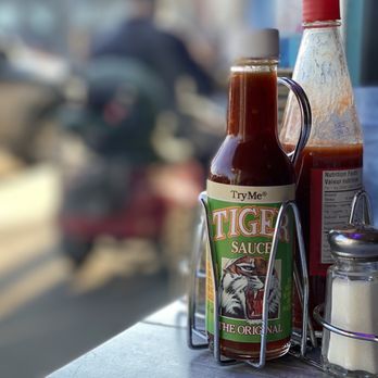 Dadeo - bottles of hot sauce and ketchup on a table - Southern Near Me - Edmonton, Alberta