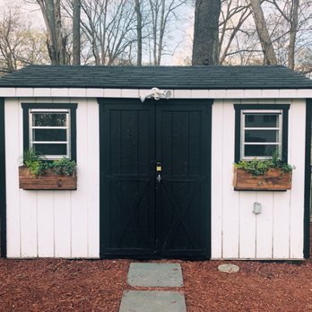 Twinbrook Farms - a white shed with black shutters - Nurseries & Gardening Near Me - Franklin Lakes, New Jersey