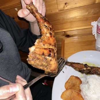 West African Way - a person holding a fork over a plate of food - African Near Me - Plano, Texas West African Way - a person holding a fork over a plate of food - African Near Me - Plano, Texas