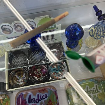 Best Daze - refused to exchange. - A glass display case contains glass pipes, accessories, and cannabis-related items, including a box of glass bowls and decorative glass pieces. - Cannabis Clinics Near Me - Santa Fe, New Mexico