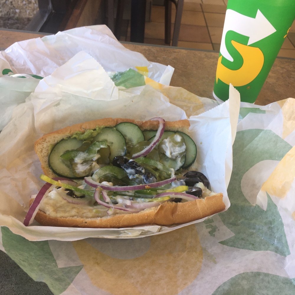 a sandwich and a drink on a table