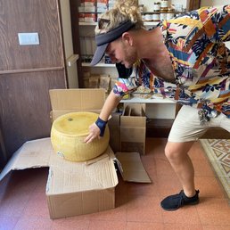Arturo describing a fresh wheel of Parmesan cheese.