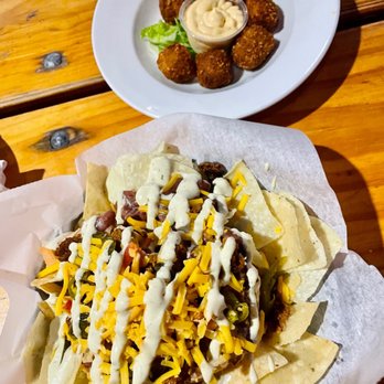Ernst Cafe - a plate of nachos and a plate of fried tater tots - Cajun/Creole Near Me - New Orleans, Louisiana