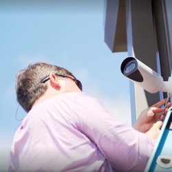 Pollock Company - Pollock Company employee installing physical security devices for local company