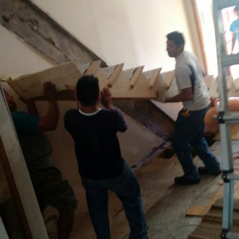 Mendoza Construction - Lifting in place the new staircase by the workers. - General Contractors Near Me - Jersey City, New Jersey Mendoza Construction - Lifting in place the new staircase by the workers. - General Contractors Near Me - Jersey City, New Jersey