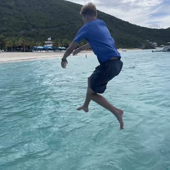 Stormy Pirates Boat Charters - Jumping off the boat to swim to Soggy Dollar on Jost Van Dyke. - Boat Charters Near Me