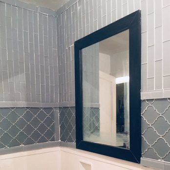 A&C Solutions - Bathroom tile installation with a freshly painted mirror - General Contractors Near Me