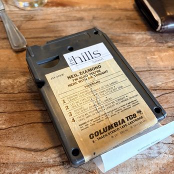 The Hills - The bill comes out using an old 8-track! - New American Near Me - Tucson, Arizona The Hills - The bill comes out using an old 8-track! - New American Near Me - Tucson, Arizona