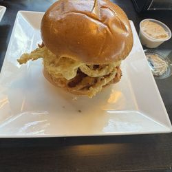 Grilled chicken sandwich with fried onion straws and blue cheese dressing