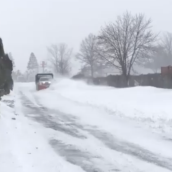 Martin Landscaping - a truck driving down a snowy street - Landscaping Near Me Martin Landscaping - a truck driving down a snowy street - Landscaping Near Me