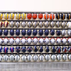 Sports Studio - As the trusted entertainment partner for the NFL, we keep a "Great Wall" of NFL helmets.