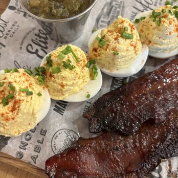 Magnolia Table - Deviled eggs with sweet thick slab bacon and jalapeño jelly. Great for sharing! - Breakfast & Brunch Near Me - Waco, Texas Magnolia Table - Deviled eggs with sweet thick slab bacon and jalapeño jelly. Great for sharing! - Breakfast & Brunch Near Me - Waco, Texas
