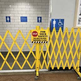 a yellow gate with a sign that says stop your toilet a yellow gate with a sign that says stop your toilet