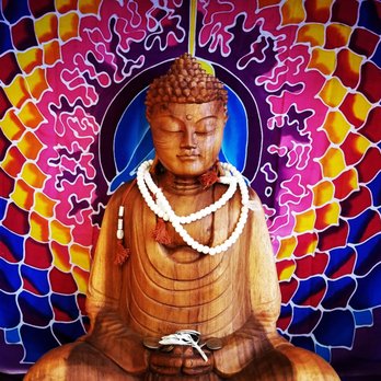 Moonrise Herbs - a buddha statue in front of a colorful background - Health Markets Near Me - Arcata, California