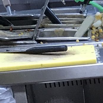 Pollo Tropical - a kitchen with a bunch of clutter on the counter - Fast Food Near Me - Miami, Florida
