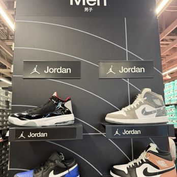Nike - A retail display showcases four pairs of men's Jordan sneakers, each on individual platforms, with signage indicating the Jordan brand. - Sports Wear Near Me - Central Valley, New York