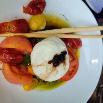 Bites & Bubbles - Tomato Burrata Mozzarella - Sliced tomatoes, Italian confit tomatoes, fresh burrata mozzarella, basil pesto - Wine Bars Near Me - Orlando, Florida