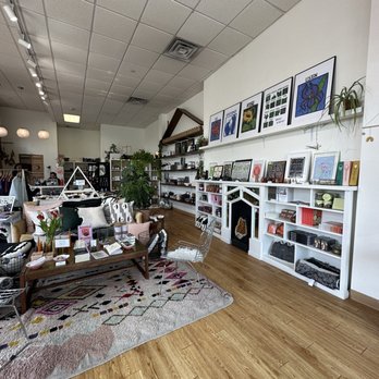 HausWitch - A store interior featuring shelves with crystals, artwork, and decorative items, along with a seating area on a patterned rug. - Spiritual Shop Near Me - Salem, Massachusetts