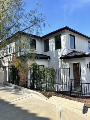 South Pasadena - This modern single-family home was custom-built in South Pasadena, nestled on a sloped lot with sweeping mountain views. Thoughtfully designed for both form and function, the home features 4 spacious bedrooms, 3 full baths, and a two-car garage — all within 2,696 square feet of clean, contemporary living space.

The exterior boasts a sharp, modern profile with smooth stucco, black-trimmed windows, and a flat tile roof, blending seamlessly into the hillside landscape. Inside, the open-concept kitchen showcases a mix of natural wood and white cabinetry, dramatic veined quartz countertops, and a waterfall island perfect for entertaining. The spa-inspired bathrooms are finished with sleek black fixtures, floating vanities, and a mix of textures — including matte penny tile and custom glass shower enclosures — for a high-end, designer feel.

Natural light floods the interiors thanks to oversized windows and a smart layout that maximizes the lot’s elevation. Every detail was chosen to enhance livability and aesthetic appeal, creating a home that feels both elevated and inviting.