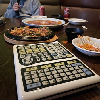 Assa Tech Karaoke - a man sitting at a table with a calculator - Karaoke Near Me - Duluth, Georgia