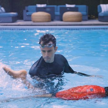 Swim Lessons Vancouver - Founder and head instructor Diogo correcting the flutter kick of an adult swim lesson student. - Swimming Lessons/Schools Near Me Swim Lessons Vancouver - Founder and head instructor Diogo correcting the flutter kick of an adult swim lesson student. - Swimming Lessons/Schools Near Me