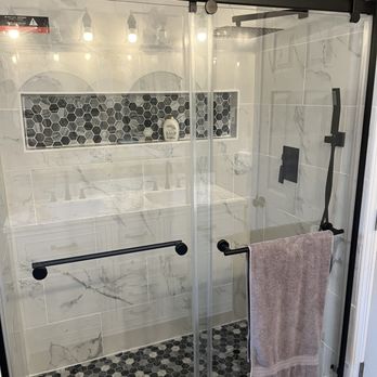 Chase & Son's - a shower with a glass door - General Contractors Near Me
