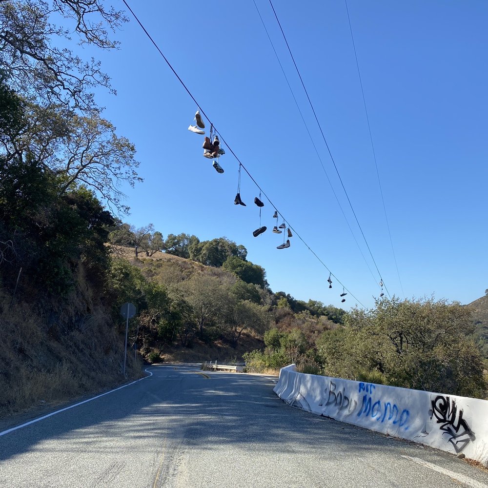 Mount Umunhum - Shoes hanging in the rope on hicks road stop sign - Hiking Near Me
