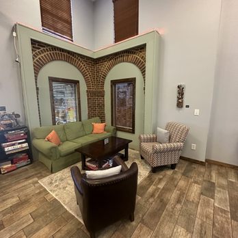 Common Grounds Coffee - a living room with a green couch - Bakeries Near Me - Ruther Glen, Virginia