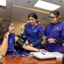 Northwest Career College - Henderson - Medical Assistant Program students at NCC Henderson campus practicing blood pressure measurement during hands-on clinical training.