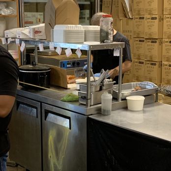 Alicia's Market - Cutting up the pork behind the counter. - Grocery Near Me - Honolulu, Hawaii Alicia's Market - Cutting up the pork behind the counter. - Grocery Near Me - Honolulu, Hawaii