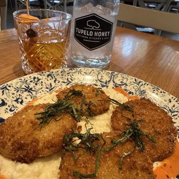 Tupelo Honey - Famous Fried Green Tomatoes* Famous Fried Green Tomatoes with goat cheese grits - American Near Me - Knoxville, Tennessee Tupelo Honey - Famous Fried Green Tomatoes* Famous Fried Green Tomatoes with goat cheese grits - American Near Me - Knoxville, Tennessee