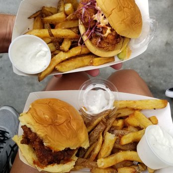 Food Box - a person holding a sandwich and fries - Food Trucks Near Me - Charleston, South Carolina Food Box - a person holding a sandwich and fries - Food Trucks Near Me - Charleston, South Carolina