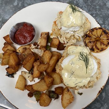 The Ice Plant - Eggs Benedict: BLUE CRAB, WHITE CHEDDAR BISCUITS, DILL HOLLANDAISE, POTATO HASH - Cocktail Bars Near Me - St. Augustine, Florida