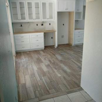 Perkins And Sons Handyman - The same kitchen, after flooring but before countertops. That floor is tile but looks warm and inviting like wood. - Handyman Near Me Perkins And Sons Handyman - The same kitchen, after flooring but before countertops. That floor is tile but looks warm and inviting like wood. - Handyman Near Me