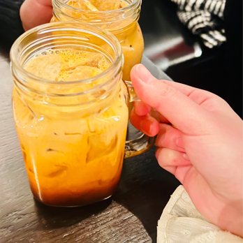 Krung Thep Thai Cuisine - a person holding a glass of iced tea - Thai Near Me - Chicago, Illinois Krung Thep Thai Cuisine - a person holding a glass of iced tea - Thai Near Me - Chicago, Illinois