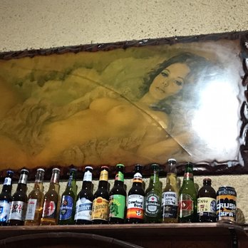 Sundown Saloon - a woman surrounded by beer bottles - Dive Bars Near Me - Houston, Texas Sundown Saloon - a woman surrounded by beer bottles - Dive Bars Near Me - Houston, Texas
