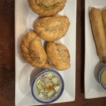 Thai At The Palace - Curry puff - pastry dough stuffed with chicken, onions, potato, and curry powder served with a cucumber sauce. - Thai Near Me - Belvidere, New Jersey