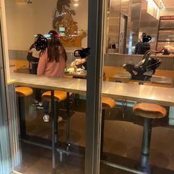 Chipotle Mexican Grill - 4 employees and a baby. Only 1 in uniform. Sitting down literally having dinner. Online orders only.