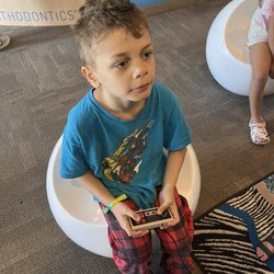 Kids Care Dental & Orthodontics - Manteca - Video games on fun seats