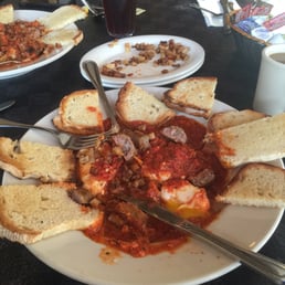 Eggs purgatory (both) with side of sausage n potatoes Eggs purgatory (both) with side of sausage n potatoes