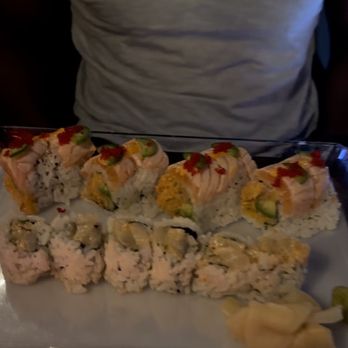Sushi Zero - a man holding a tray of sushi - Sushi Bars Near Me - Millburn, New Jersey