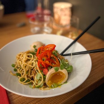 Tanoshii - a plate of noodles and vegetables with chopsticks - Japanese Near Me - Bozeman, Montana Tanoshii - a plate of noodles and vegetables with chopsticks - Japanese Near Me - Bozeman, Montana