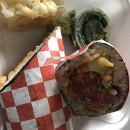 Tuna and salmon burrito with a side of seaweed salad, ginger and wasabi. Tuna and salmon burrito with a side of seaweed salad, ginger and wasabi.
