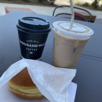 Thousand Hills Coffee - Manu, iced carmanilla, and donut with chocolate filling. - Coffee & Tea Near Me - Charlotte, North Carolina Thousand Hills Coffee - Manu, iced carmanilla, and donut with chocolate filling. - Coffee & Tea Near Me - Charlotte, North Carolina