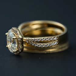 ArtGold - Close-up of a yellow gold halo engagement ring with a diamond split shank and wedding band, photographed at Art Gold Jewelry in Everett, MA.