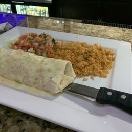 Grilled chicken burrito topped with cheese dip. :) just a smidge spicy that's all and just enough. Rice on the side. Grilled chicken burrito topped with cheese dip. :) just a smidge spicy that's all and just enough. Rice on the side.