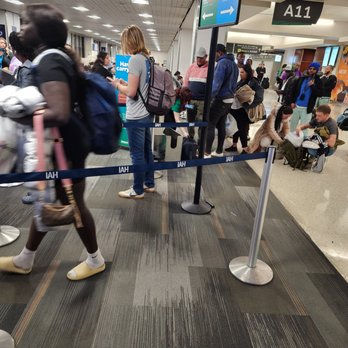 Frontier Airlines - At gate A1, IAH airport. Disgruntle counter agent yelling at passengers while using the carry on measuring tool. - Airlines Near Me - Denver, Colorado